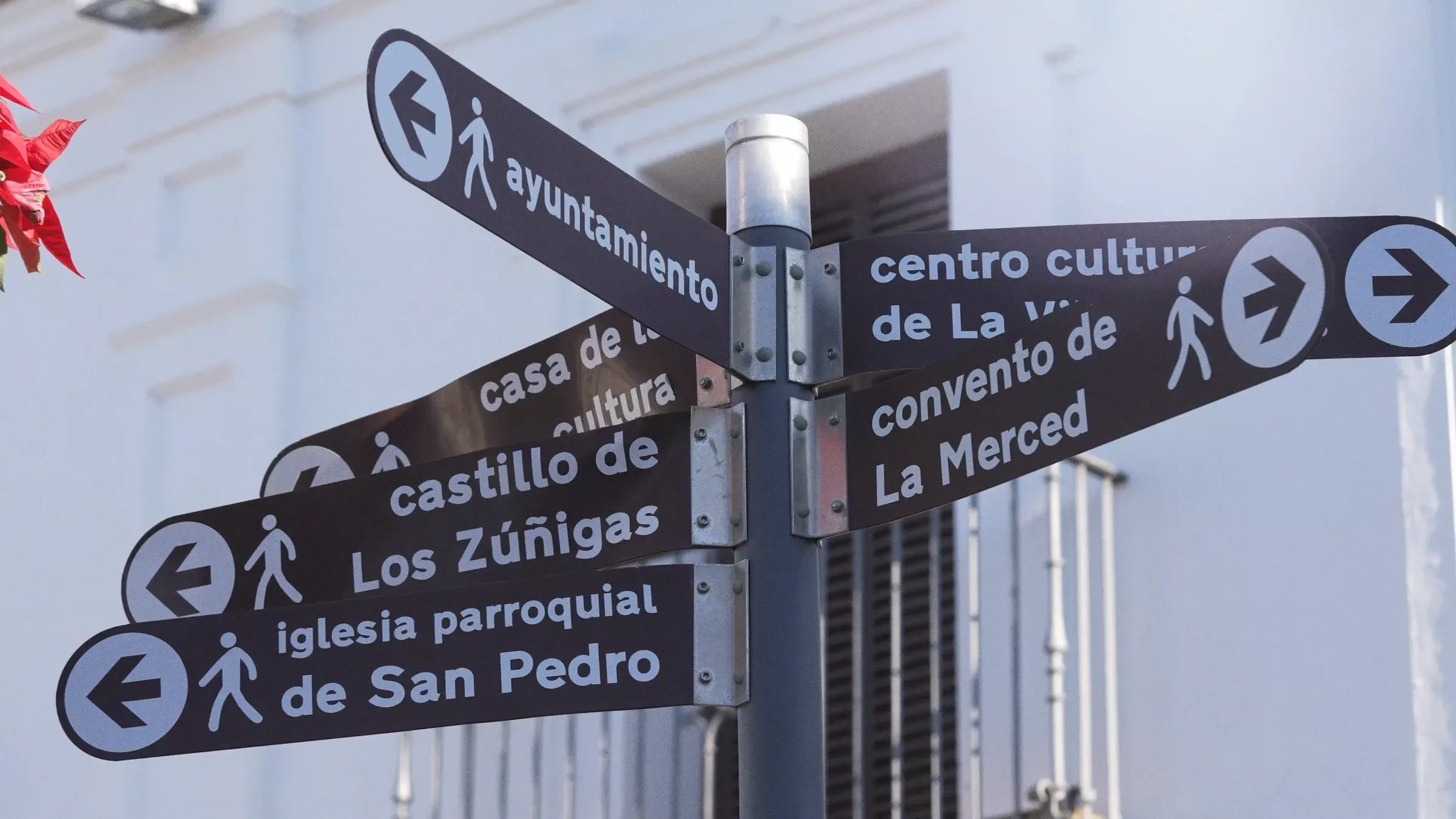 Poste de señales peatonales en el centro de Cartaya, con direcciones al ayuntamiento, al castillo de Los Zúñigas y a la iglesia de San Pedro